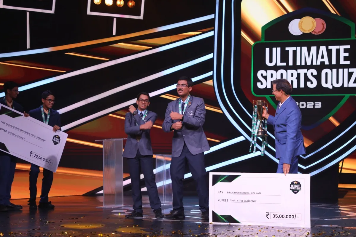 Winners celebrate with cheques and trophy